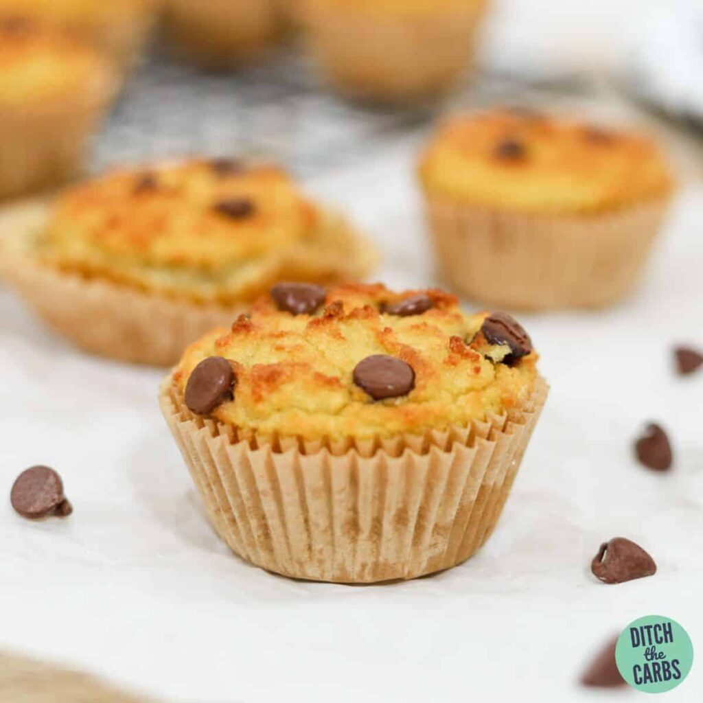 Keto chocolate chips muffins spread out over parchment paper.