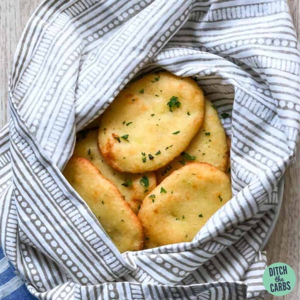 Keto naan bread wrapped in a towel to keep warm.