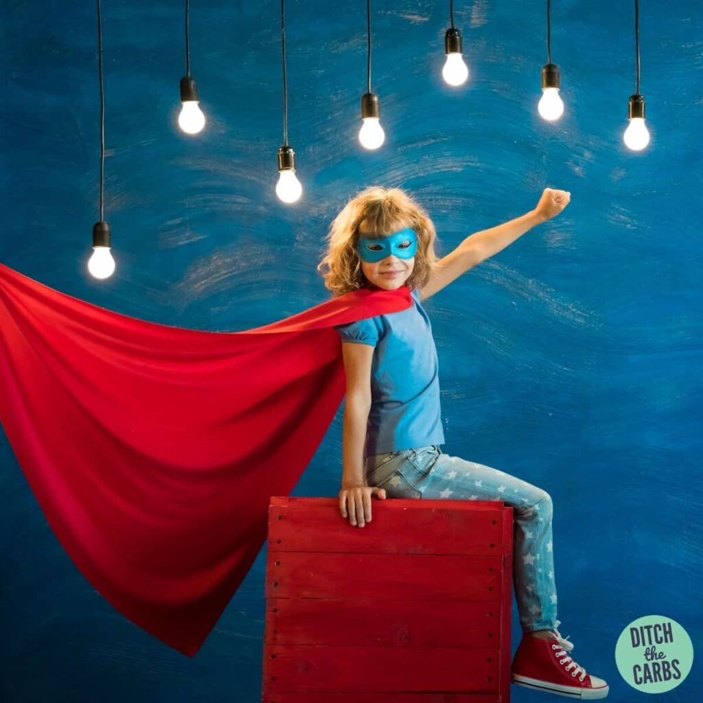 boy on a box with a red cape