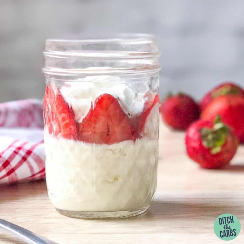 strawberry keto mug cheesecake in a glass mason jar